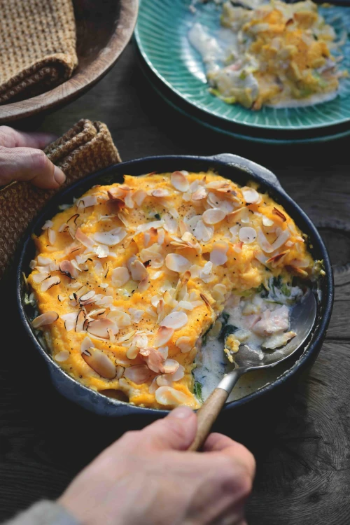 Vis parmentier met pompoen en amandelpuree